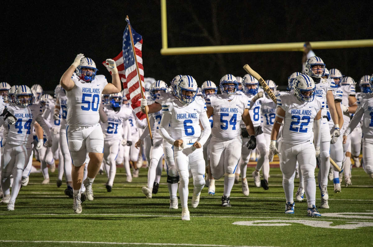 Highlands High School varsity football team runs out before the state semi-finals start.